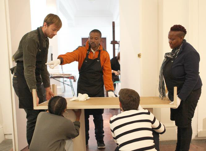Click the image for a view of: The exhibition in progress with the students working