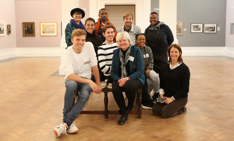 Click the image for a view of: A short break from the instillation for a group photograph within the week
